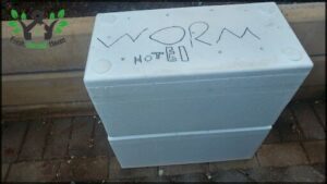 A white cooler with the word "worm" written on it.