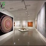A white room with a large painting on the wall.