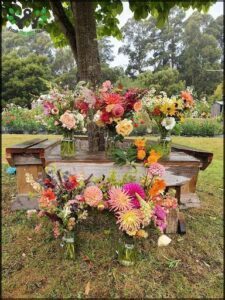 A wooden bench is adorned with a beautiful floral arrangement.