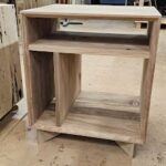 A wooden table with a shelf on top.