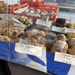 A bakery display with a variety of pastries, including croissants, cakes, and cookies.