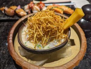 A bowl of food with a spoon in it.