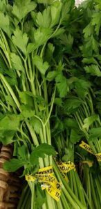 A bunch of green vegetables are displayed on a table.