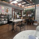 A cafe with a wooden floor and a table with chairs.