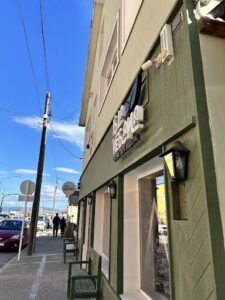 A caption for the image could be "A view of a storefront with a sign that says 'Boutique'."