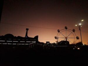 A carousel with a purple sky in the background.
