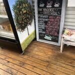 A chalkboard menu lists various types of coffee.