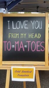 A chalkboard sign that says "I love you from my head to my toes."