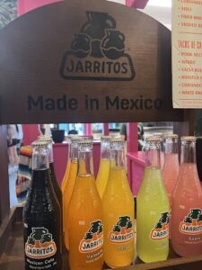 A display of various flavored Jarritos soda bottles.