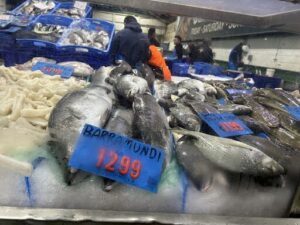 A fish market with a large display of fish.