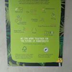 A green poster with a picture of a tree on it.