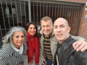A group of four people, two men and two women, are posing for a picture together.