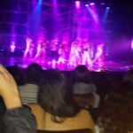 A group of people are performing on stage in front of a crowd.