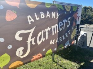 A large banner advertising the Albright Farmers Market.