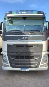 A large black and white truck with a Volvo logo on the front.