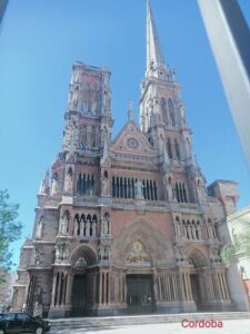 A large, old church with a tall steeple and a cross on top.
