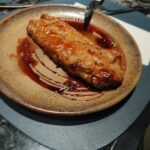 A plate of food with a fork and knife on it.