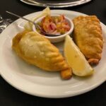 A plate of food with a lemon wedge on top.