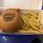 A sandwich and fries in a box.