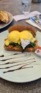 A sandwich with eggs and sauce on a plate.