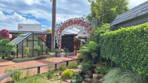 A sign that says Gardenworld is in front of a building.