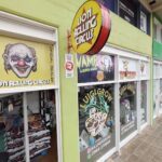 A storefront for a carnival with a clown face on the window.