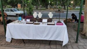 A table full of jewelry and other items is set up for a sale.