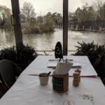 A table with a white tablecloth and a cup of coffee on it.