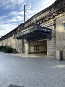 A train station with a train coming in.