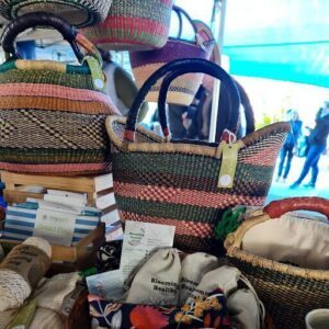 A variety of woven bags are displayed on a table, including a large woven bag and a smaller one.