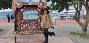 A woman poses in front of a sign that reads "Shushuai."