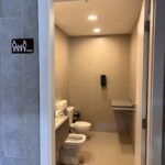 A bathroom with a toilet and a sink.