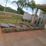 A beautiful garden with a variety of plants and a patio.