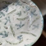 A blue and white bowl with a leaf design on it.