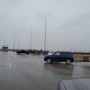 A blue SUV is parked in a parking lot, surrounded by other vehicles.