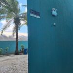 A blue wall with a sign on it.