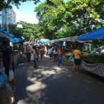 A bustling marketplace filled with people shopping and vendors selling their goods.