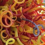 A colorful glass sculpture with a variety of shapes and sizes.