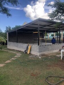 A construction site with a brick building under construction.