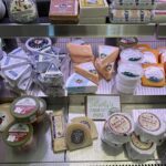 A display of cheeses and other food items in a store.