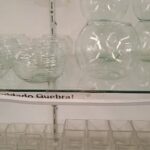 A display of glass vases on a shelf.