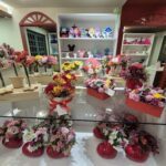 A flower shop filled with various flowers and vases.