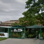 A greenhouse with a sign that says "Viva" on the door.