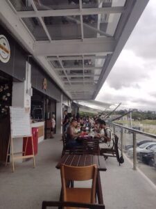 A group of people are gathered at a restaurant, enjoying their meal together.