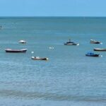 A large body of water with several boats floating on it.