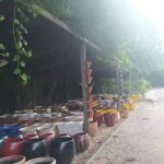 A large collection of pots and vases are displayed outside, ready to be sold.