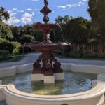 A large fountain with a statue of a man and a bird on top.