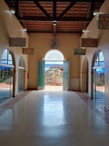 A large open building with a clock on the wall.