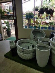 A large variety of pots and vases are displayed in a store.