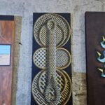 A painting of a snake is displayed on a wall.